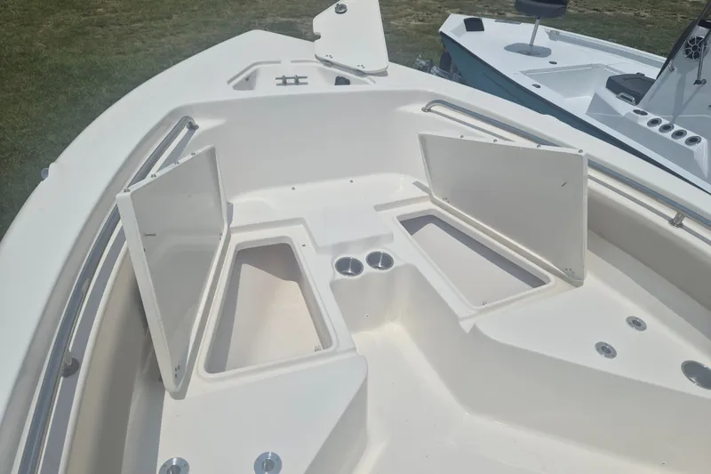 Slide: The Image of 2026 Key West 203 FS boat interior with open storage compartments and cup holders. - 17