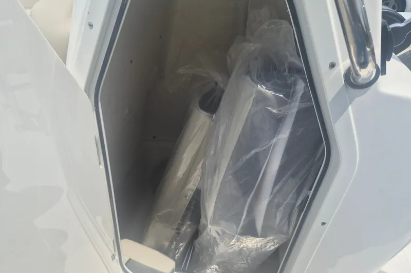 Slide: The Image of Storage compartment of 2026 Key West 203 FS boat with wrapped items inside. - 15