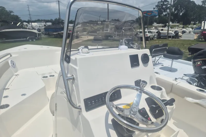 Slide: The Image of 2026 Key West 203 FS boat dashboard with steering wheel and controls. - 10
