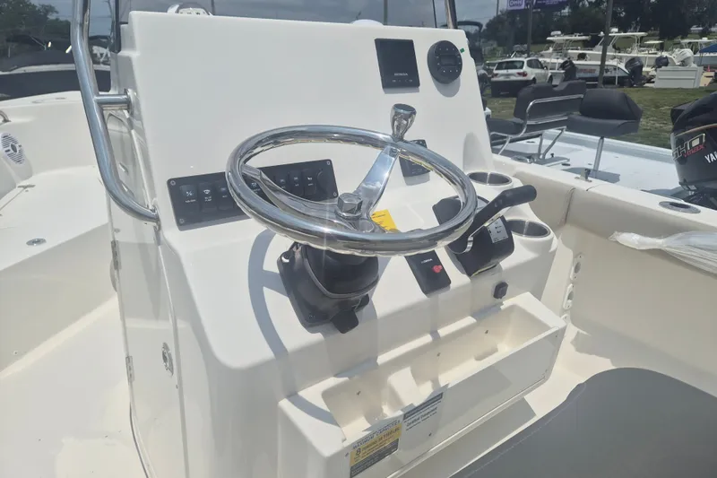 Slide: The Image of 2026 Key West 203 FS boat console with steering wheel and controls. - 9