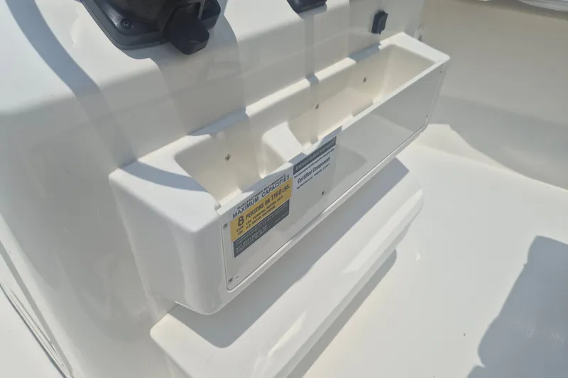 Slide: The Image of Key West 203 FS 2026 boat console with storage compartment and capacity label. - 11