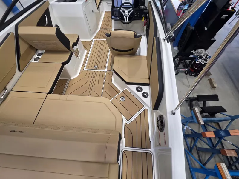 Slide: The Image of Interior view of a Sea Ray SPX 210 boat with beige seating and a modern steering wheel. - 11