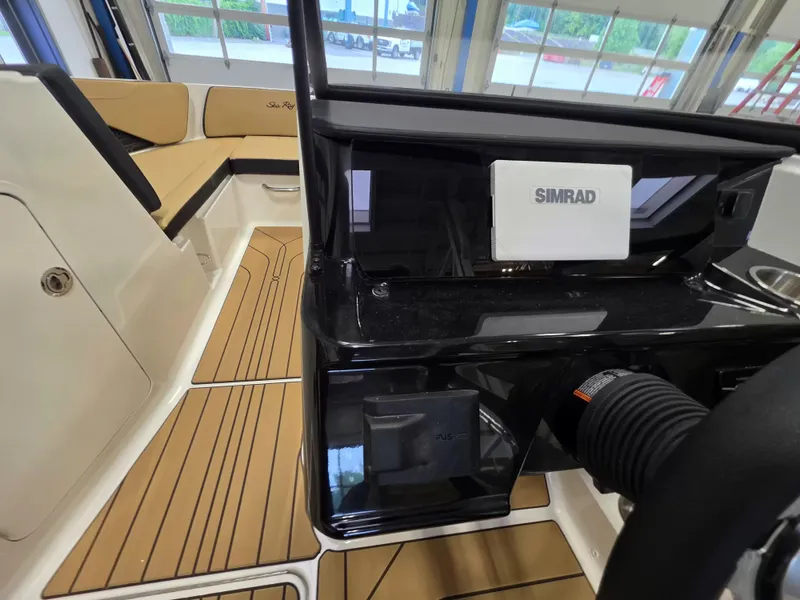 Slide: The Image of The image shows the cockpit of a Sea Ray SPX 210 boat with modern navigation systems. - 17