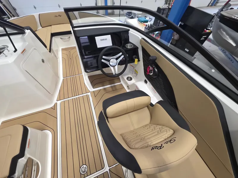 Slide: The Image of The image shows the cockpit of a Sea Ray SPX 210 boat with a sleek steering wheel and comfortable seating. - 13