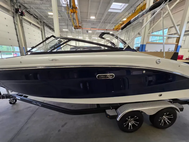 Slide: The Image of A 2027 Sea Ray SPX 210 boat on a trailer inside a warehouse. - 3