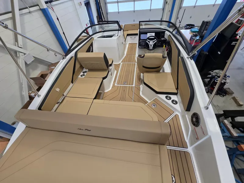 Slide: The Image of Interior view of a Sea Ray SPX 210 boat with beige seating and modern design. - 10
