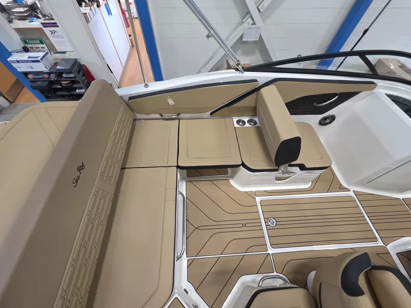 Slide: The Image of The image shows the cockpit of a Sea Ray SPX 210 boat with beige upholstery and wood flooring. - 12