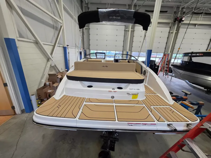 Slide: The Image of The image shows a 2027 Sea Ray SPX 210 boat in a warehouse setting. - 5