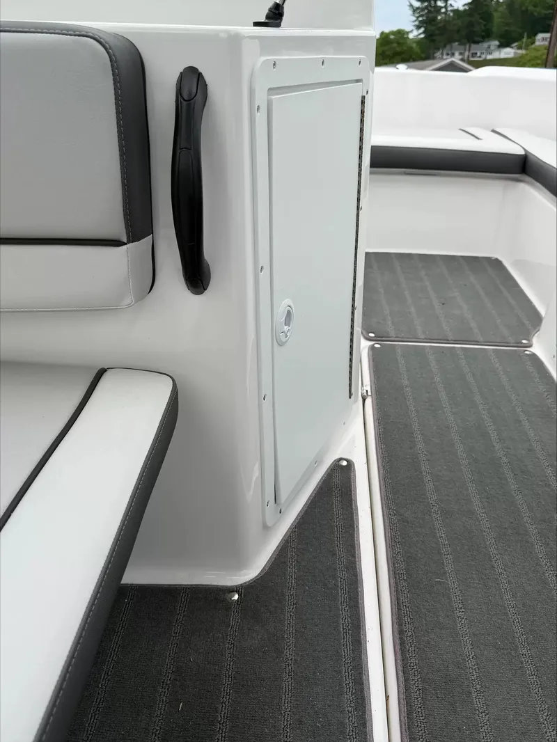 Slide: The Image of The image shows the interior of a Sea Ray SPX 210 boat with gray upholstery and carpeting. - 22