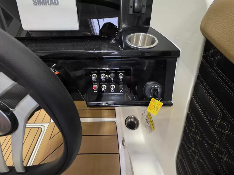 Slide: The Image of Dashboard of a Sea Ray SPX 210 with controls and a cup holder. - 15