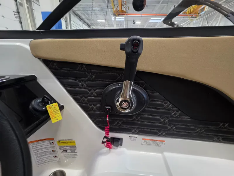 Slide: The Image of Close-up of the helm area in a Sea Ray SPX 210 boat, featuring a throttle and control panel. - 16
