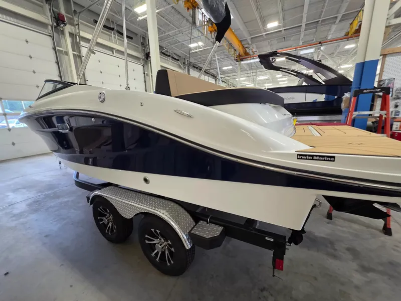 Slide: The Image of A 2027 Sea Ray SPX 210 boat on a trailer in a warehouse setting. - 4