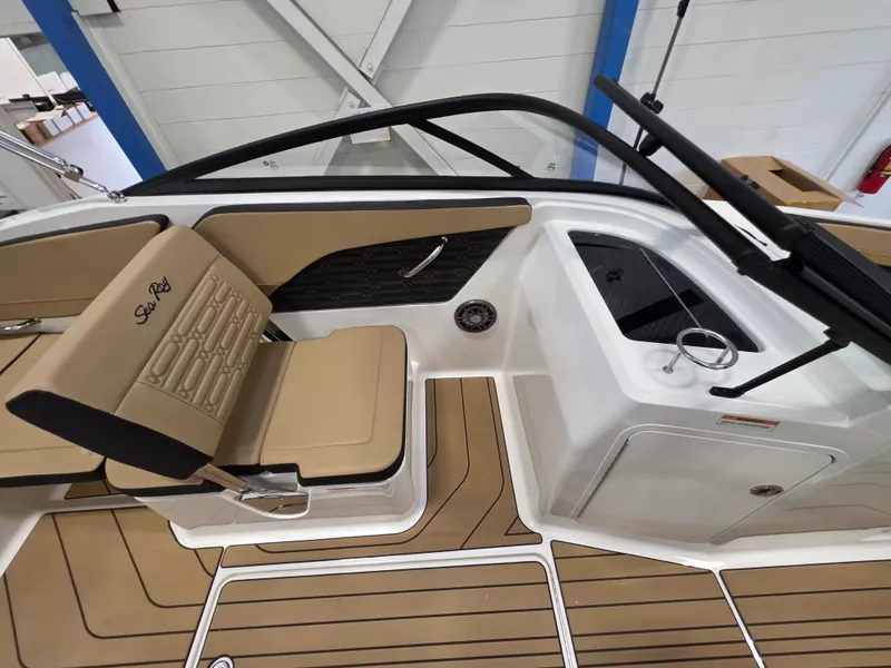 Slide: The Image of The image shows the cockpit of a Sea Ray SPX 210 boat with beige seats and wood flooring. - 18