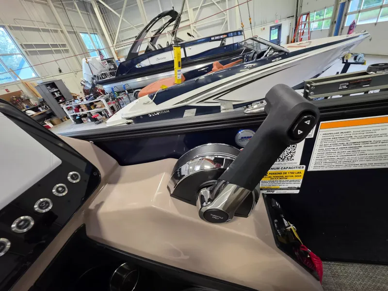 Slide: The Image of Close-up of the throttle lever of a Barletta ARIA 22UC in a boatyard. - 15