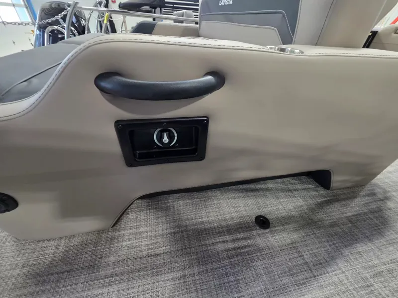 Slide: The Image of Close-up of a seat on a Barletta ARIA 22UC boat, featuring a handle and a speaker. - 11