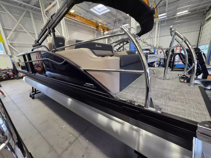 Slide: The Image of The image shows a 2027 Barletta ARIA 22UC pontoon boat in a warehouse. - 5