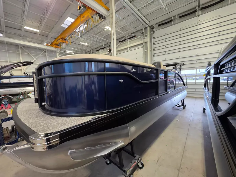 The Image of The image shows a 2027 Barletta ARIA 22UC pontoon boat in a warehouse. - 1