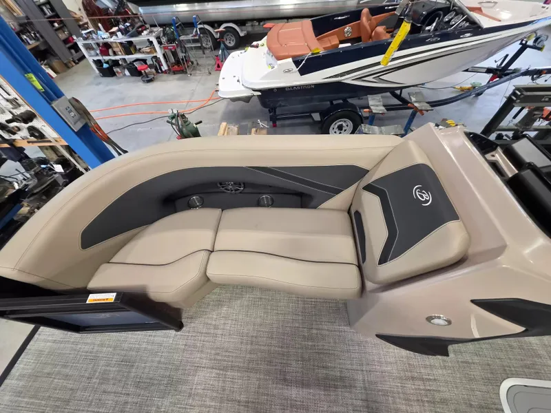 Slide: The Image of Interior view of a 2027 Barletta ARIA 22UC with beige and black upholstered seating. - 22