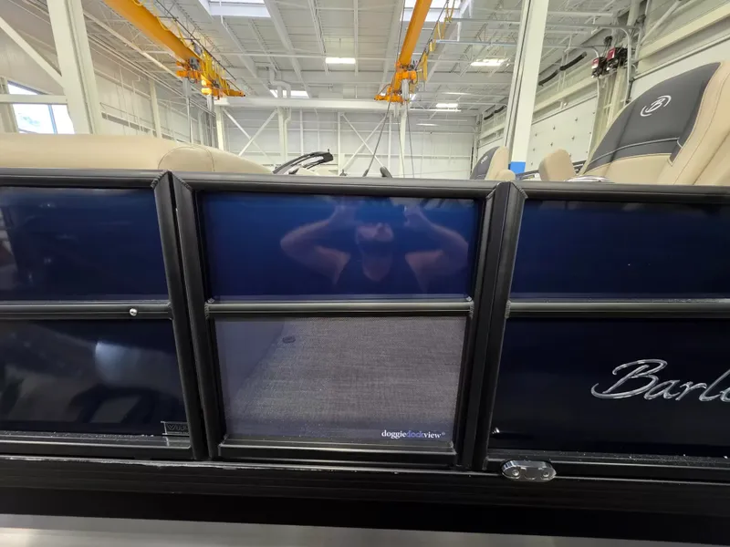 Slide: The Image of The 2027 Barletta ARIA 22UC is in a large warehouse. It features blue side panels. - 4