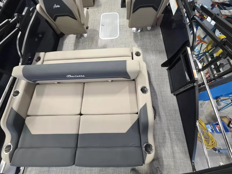 Slide: The Image of The image shows the interior of a Barletta ARIA 22UC boat with beige and gray seating. - 9