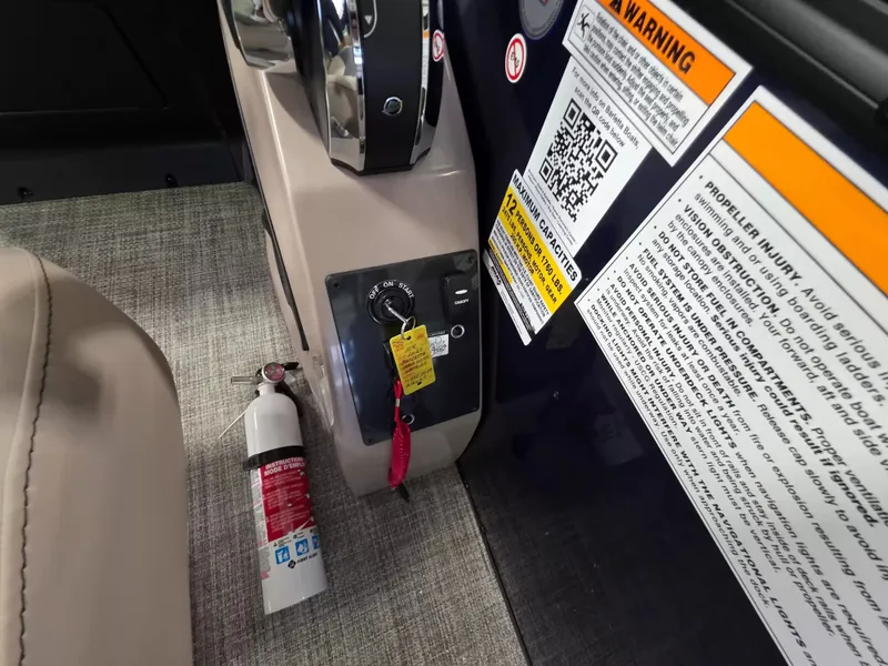 Slide: The Image of Close-up of a boat helm with ignition key and fire extinguisher. - 14