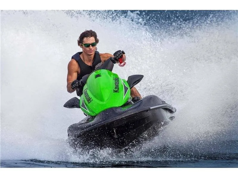Slide: The Image of A man rides a green Kawasaki Jet Ski STX-15F on the water, splashing waves around. - 6