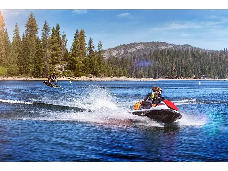 Slide: The Image of Two people ride a Kawasaki Jet Ski STX 160 on a lake surrounded by trees. - 13