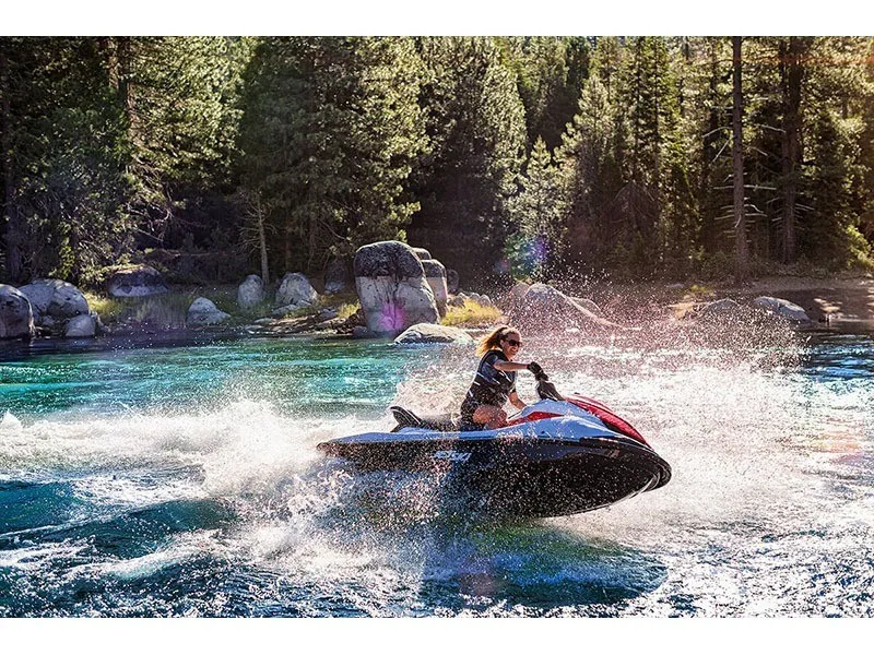 Slide: The Image of A person rides a Kawasaki JET SKI STX 160 on a clear lake surrounded by trees. - 16