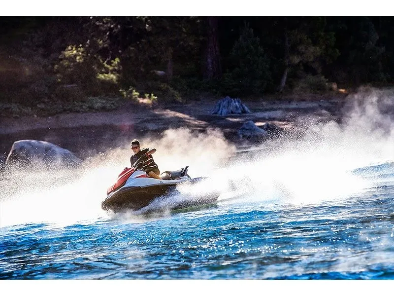 Slide: The Image of A 2021 Kawasaki JET SKI STX 160 speeding across the water, surrounded by splashing waves. - 15