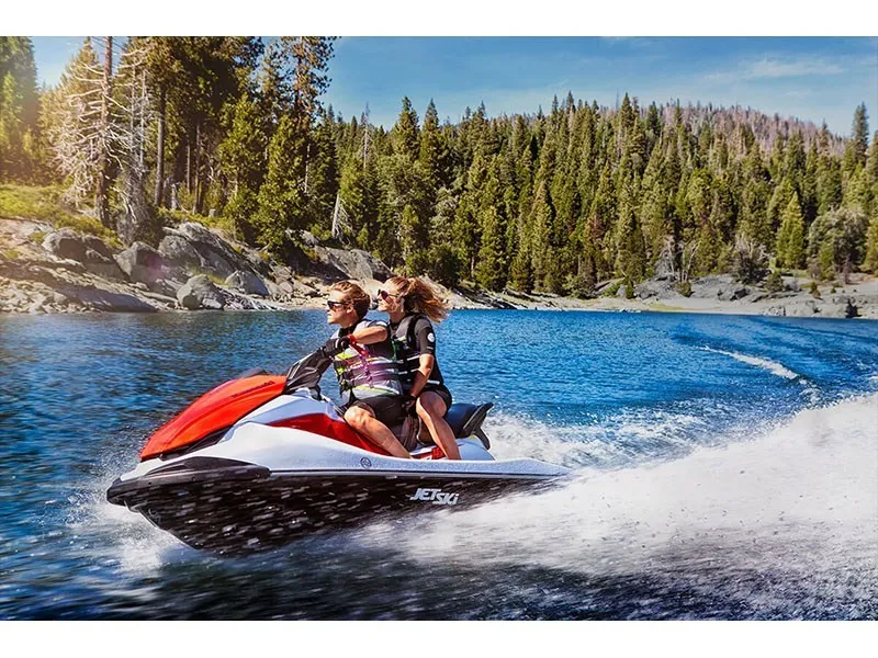 Slide: The Image of Two people ride a Kawasaki JET SKI STX 160 across a lake surrounded by forest. - 9