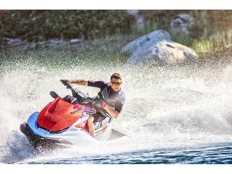 Slide: The Image of A man rides a Kawasaki JET SKI STX 160 on a lake, splashing water around. - 10