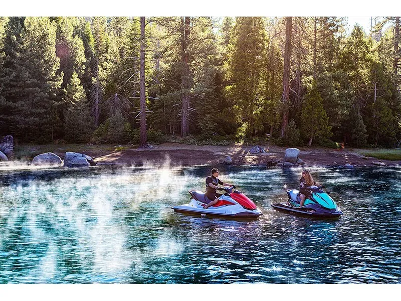 Slide: The Image of Two people ride Kawasaki jet skis on a calm lake surrounded by forest. - 14