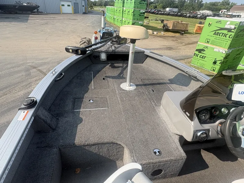 Slide: The Image of The image shows the deck of a 2014 Crestliner 1850 Fish Hawk boat with gray carpeting. - 10