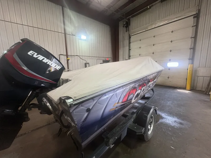 Slide: The Image of A 2014 Crestliner 1850 Fish Hawk with Evinrude motor in a storage facility. - 8