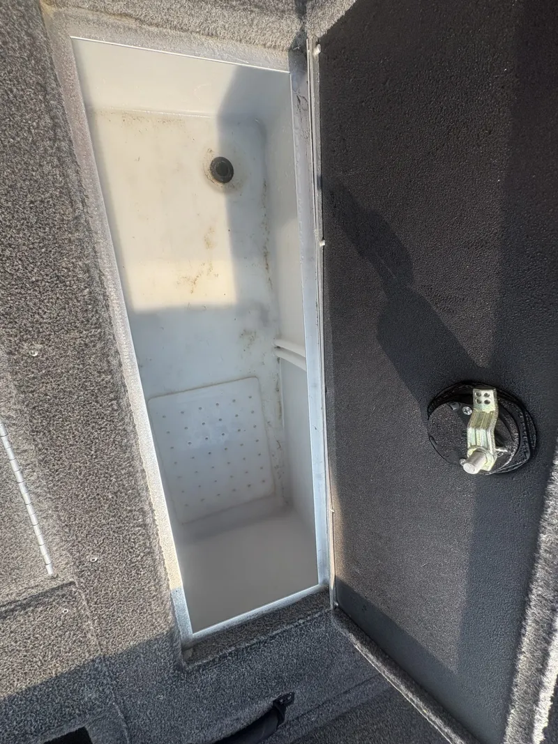 Slide: The Image of An open storage compartment on a 2014 Crestliner 1850 Fish Hawk boat. - 19