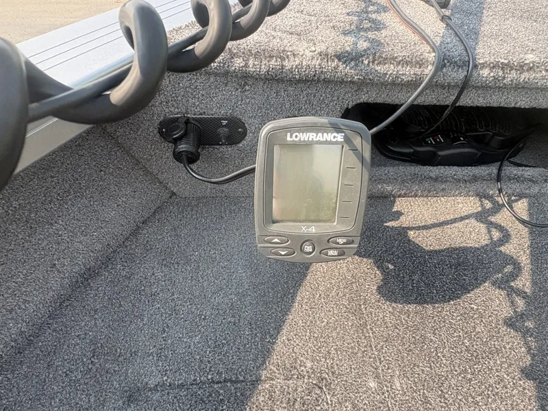 Slide: The Image of A Lowrance fish finder is mounted on the gray carpeted deck of a 2014 Crestliner 1850 Fish Hawk. - 13