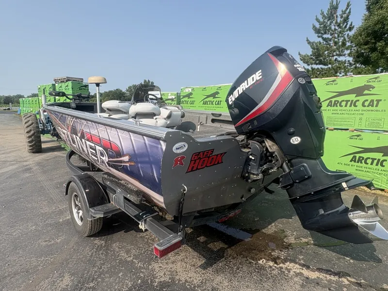 Slide: The Image of A 2014 Crestliner 1850 Fish Hawk boat with an Evinrude motor, parked on a trailer. - 6