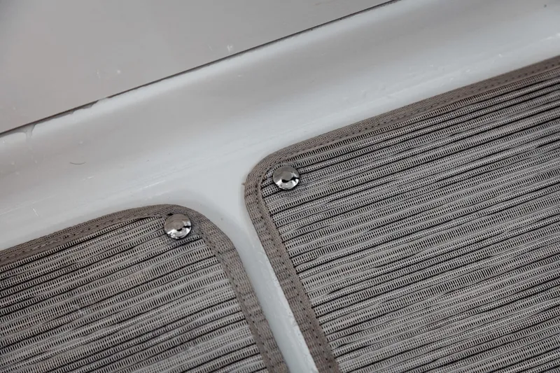 Slide: The Image of Close-up of textured floor mats with metal buttons on a boat. - 37