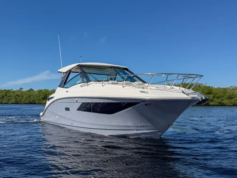 Slide: The Image of Sea Ray Sundancer 320 Outboard 2027 on calm water with clear skies. - 28
