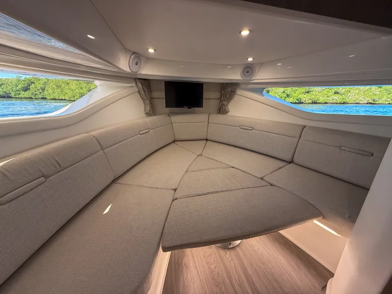 Slide: The Image of Interior of the 2027 Sea Ray Sundancer 320 Outboard with sleek gray upholstery and panoramic windows. - 21