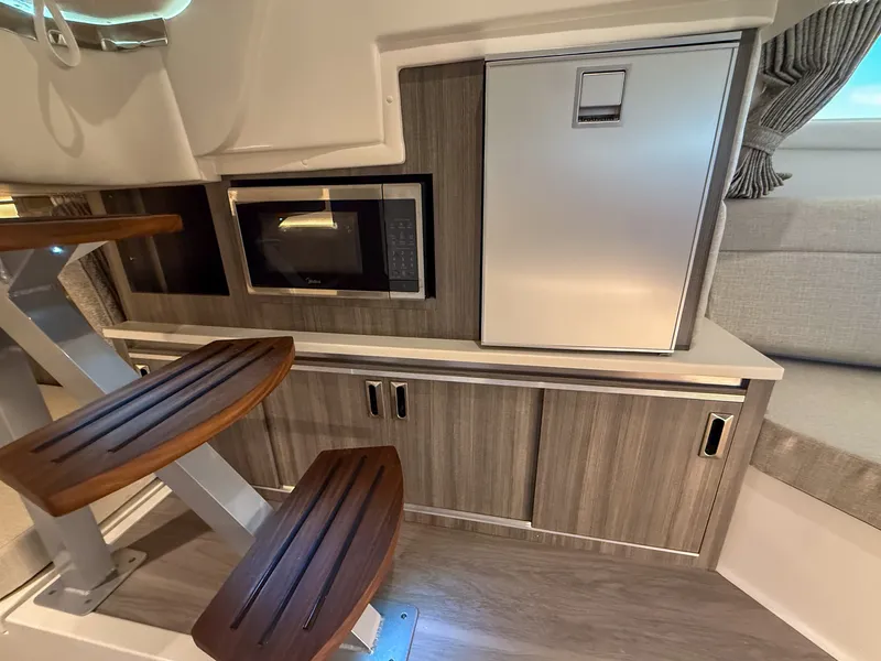 Slide: The Image of Interior of the 2027 Sea Ray Sundancer 320 Outboard with microwave and refrigerator. - 22