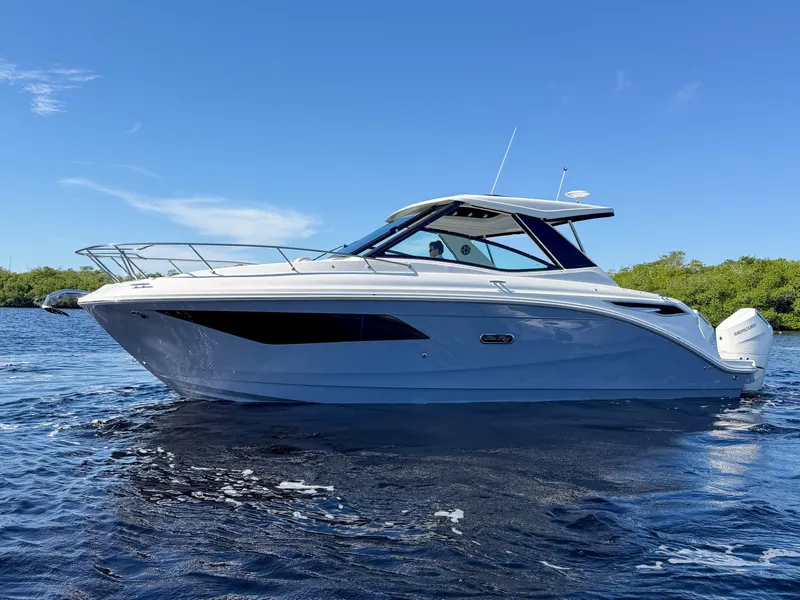 Slide: The Image of Sea Ray Sundancer 320 Outboard 2027 on calm water with clear skies. - 30