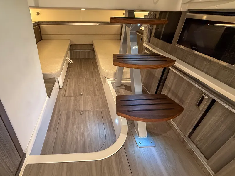 Slide: The Image of Interior of the Sea Ray Sundancer 320 Outboard with wooden steps and seating area. - 24