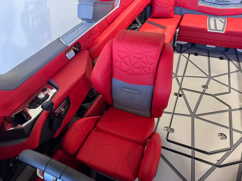 Slide: The Image of Luxurious interior of a Nautique Super Air Nautique G25 Paragon with red upholstery and modern controls. - 23
