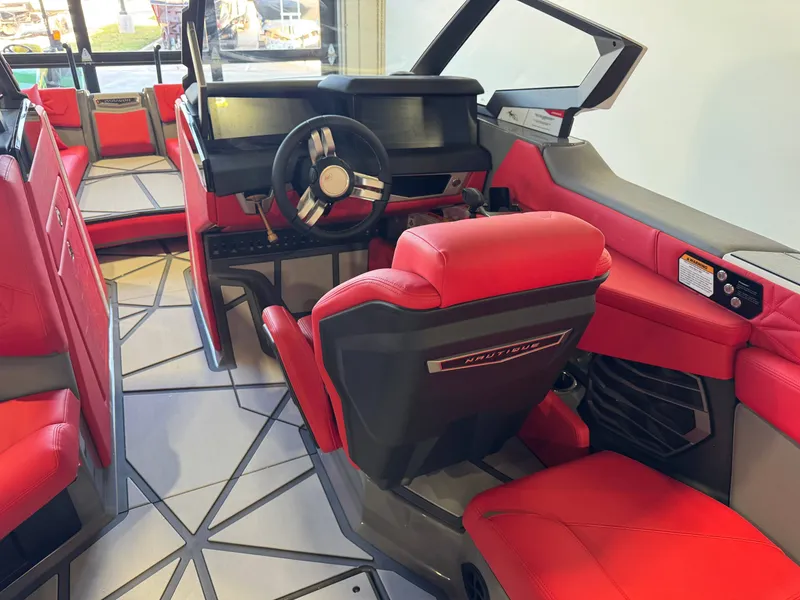 Slide: The Image of The image shows the cockpit of a Nautique Super Air Nautique G25 Paragon with red seats and a modern dashboard. - 26