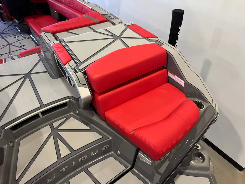 Slide: The Image of The image shows a luxurious seating area with red upholstery on a Nautique Super Air Nautique G25 Paragon boat. - 10