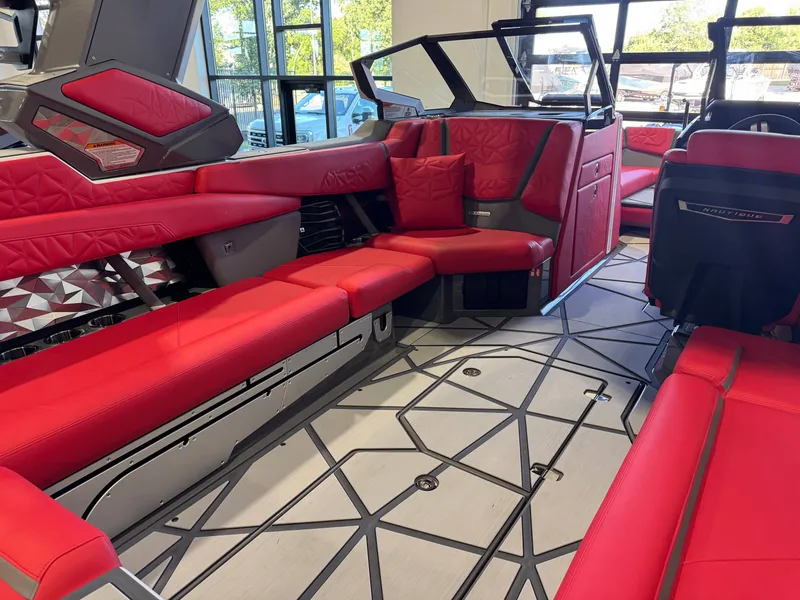 Slide: The Image of The image shows the luxurious interior of a Nautique Super Air Nautique G25 Paragon with red seating. - 16