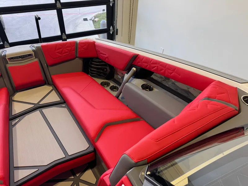 Slide: The Image of The image shows the luxurious red and gray interior of a Nautique Super Air Nautique G25 Paragon boat. - 20