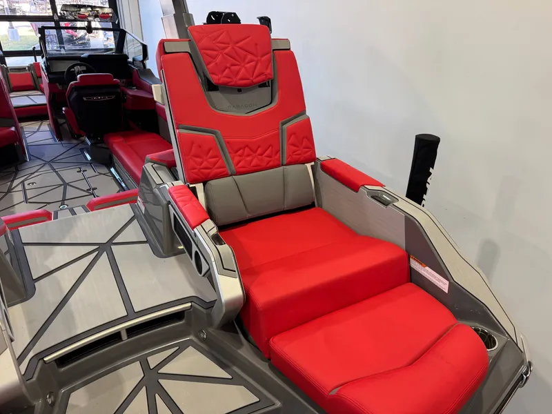 Slide: The Image of The image shows luxurious red and gray seating inside a Nautique Super Air Nautique G25 Paragon. - 13