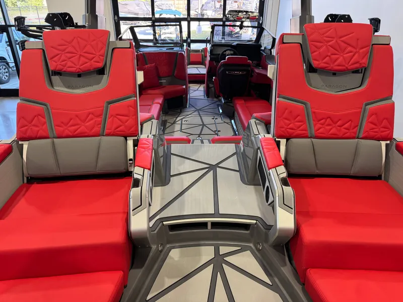 Slide: The Image of The image shows the luxurious interior of a Nautique Super Air Nautique G25 Paragon with red and gray seating. - 12